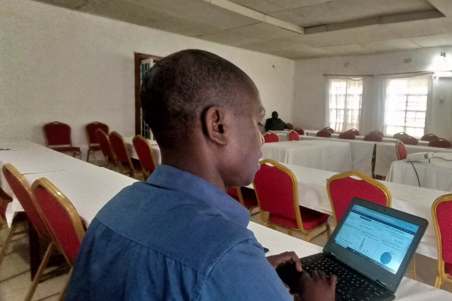 Data entry clerk Brave Kalambo entering COVID-19 vaccination data digitally