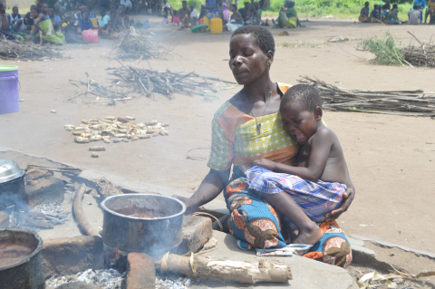 Three-year-old Lincy cries as her mother prepares a meal at Chagambatuka Primary School, their temporary shelter in Chikwawa 