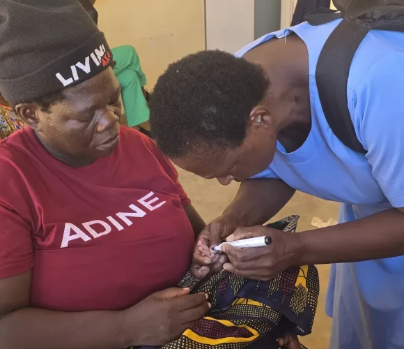 Rose Dinasi getting her newborn son finger-marked