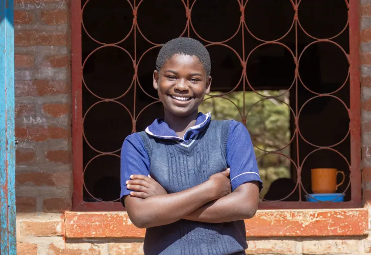 Joyce says she now enjoys learning on a desk at school.