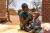 A mother feeds her child nutritious porridge in rural Lilongwe