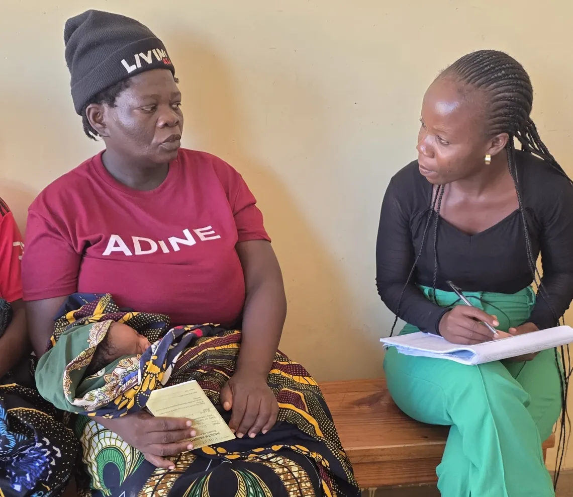 Rose registers her son with the National Registration Bureau at the health centre.