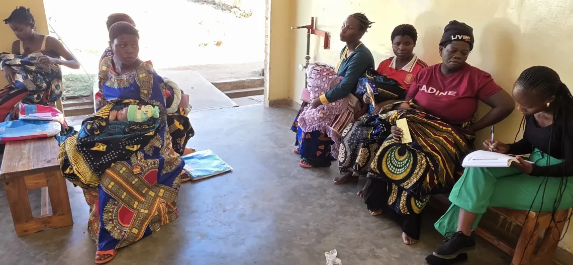Mothers holding their newborns in their hands going through a line at the section for birth registration done by the National Registration Bureau.