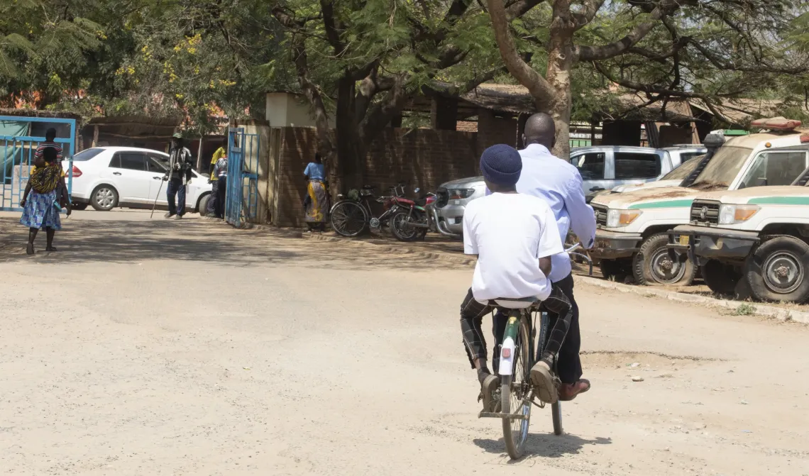 Yankho on the back of the bicycle arriving at the hospital.