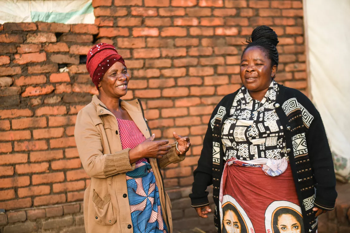Child protection co-case manager (left) Mary Changwa and Lunzu ward councillor Margaret Mictor interacting at Pasani village in Blantyre 