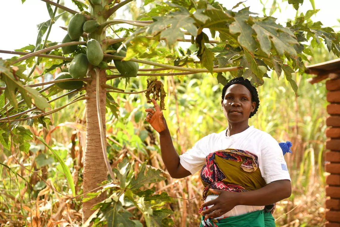 Ireen showing her Pawpaw tree at her home 