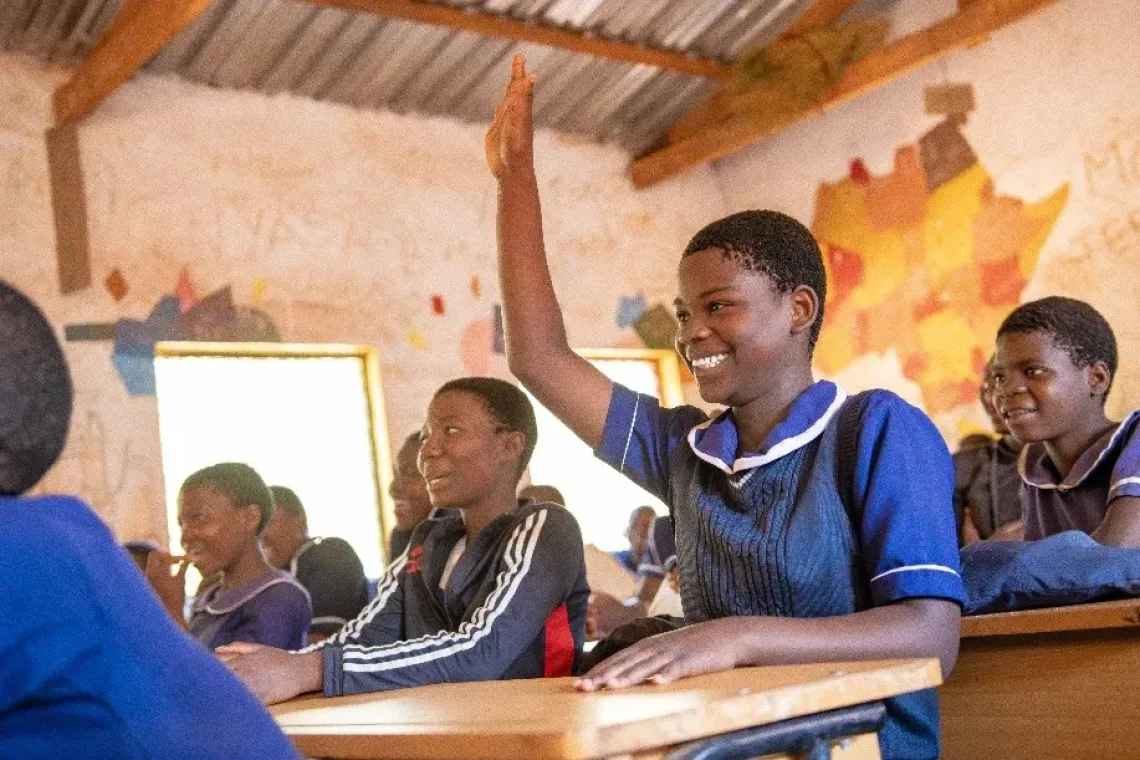 Joyce confidently raises her hand in class