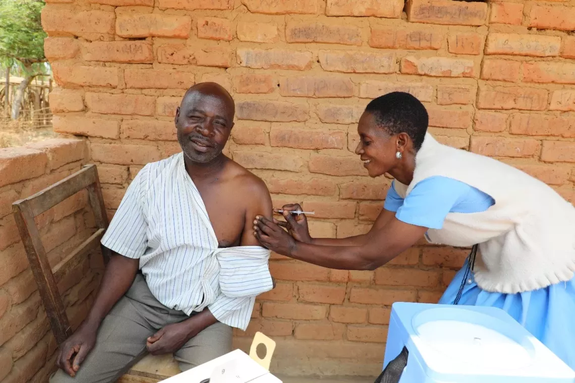 Ellington Chunga (L) facilitated collaboration with community structures to stop the spread of misinformation. Photo: &copy;  UNICEF Malawi/Given Chichitike/2024