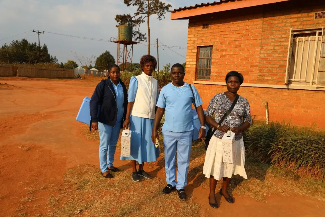 Pachane Mwale (second from right) with fellow health workers managed to vaccinate 79% of their target population under Nkholongo Health Centre in Mzimba. Photo &copy; UNICEF/Given Chichitike/2024