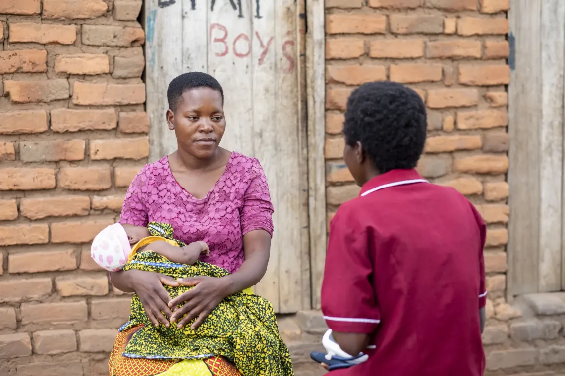 Health worker helps a mother with a baby in Rumphi District