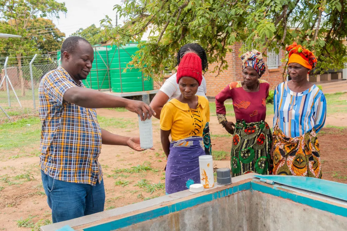 Emmanuel Nkhonjela, Assistant Water Officer at Balaka District, southern Malawi explaining water treatment process to Tiyanjane Water Committee 