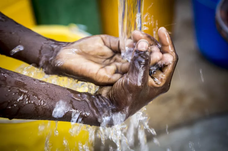 A child washes its hands at a newly built water pump in Dialangou village in Mali.