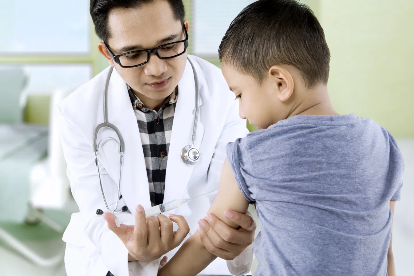 Doctor giving an injection to a child
