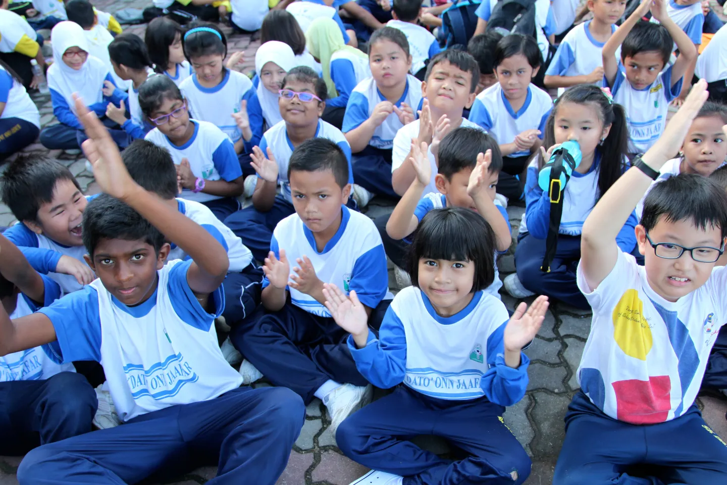 Group of young children sitting on ground
