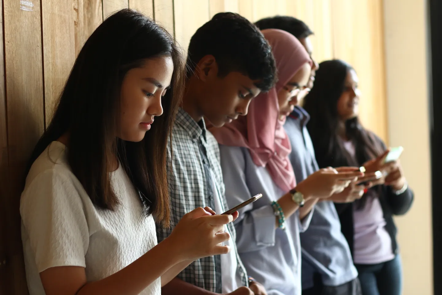 Teens looking at their phones