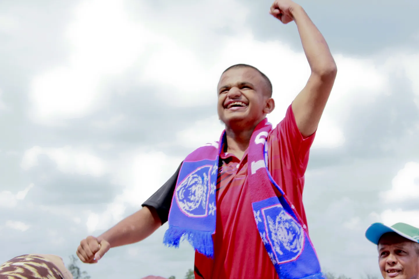 Boy smiling and celebrating at a sport event