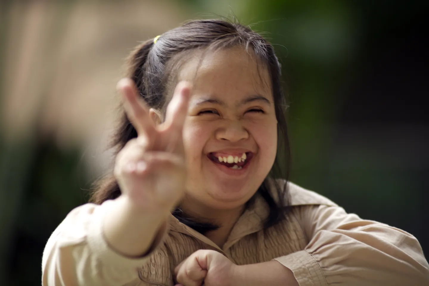 Girl child holding up peace sign