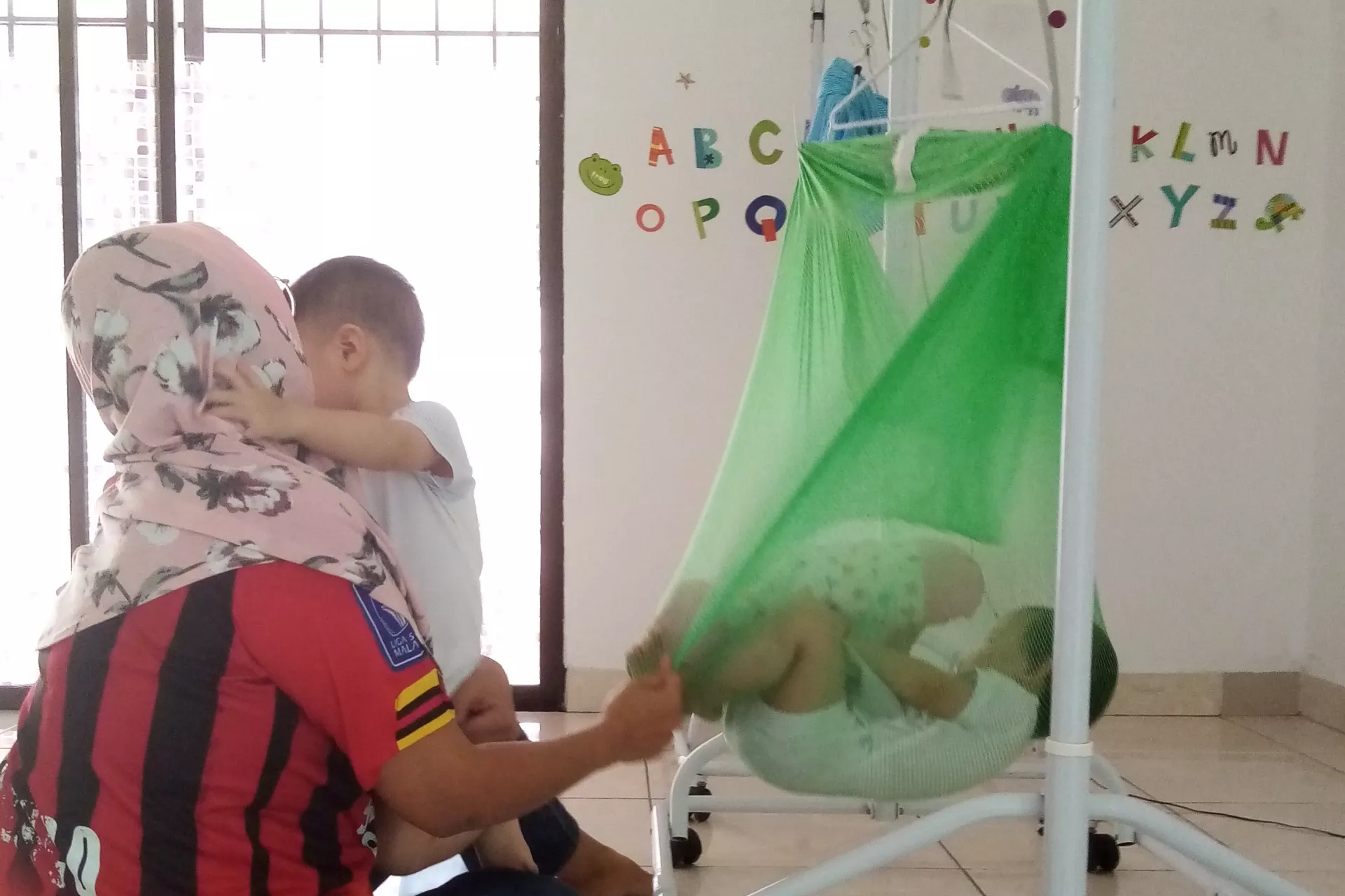 Mother tending to toddler and baby