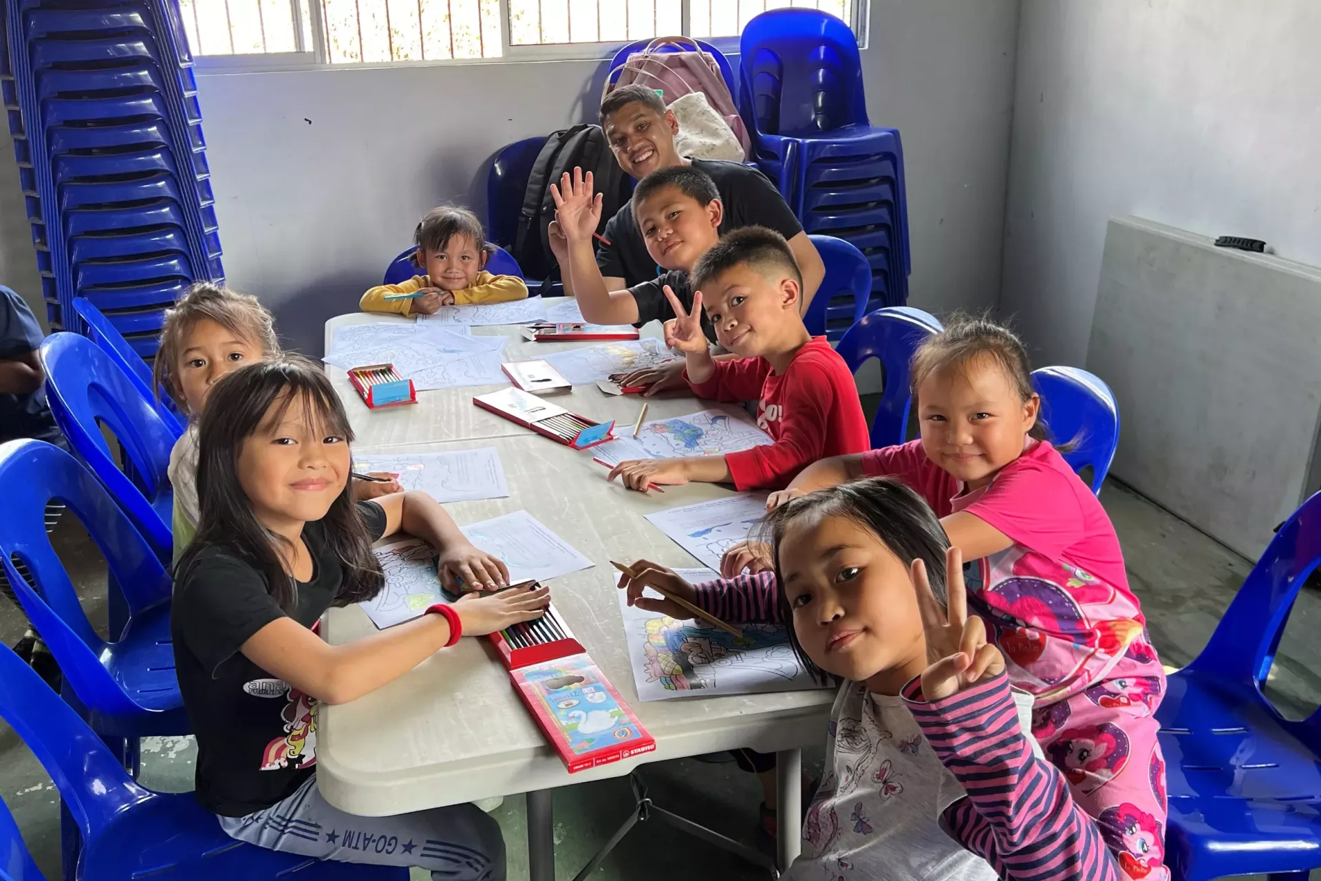Sufyan pictured with a group of children during one of DRR activities.