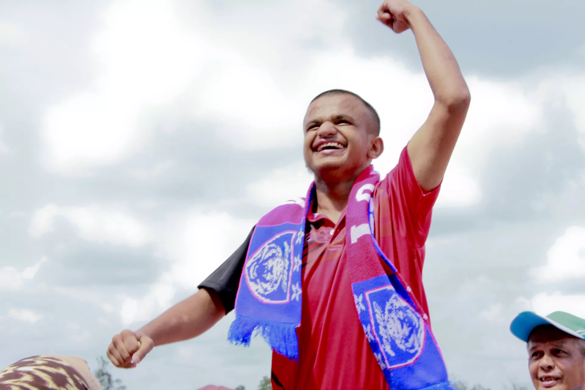 Boy smiling and celebrating at a sport event