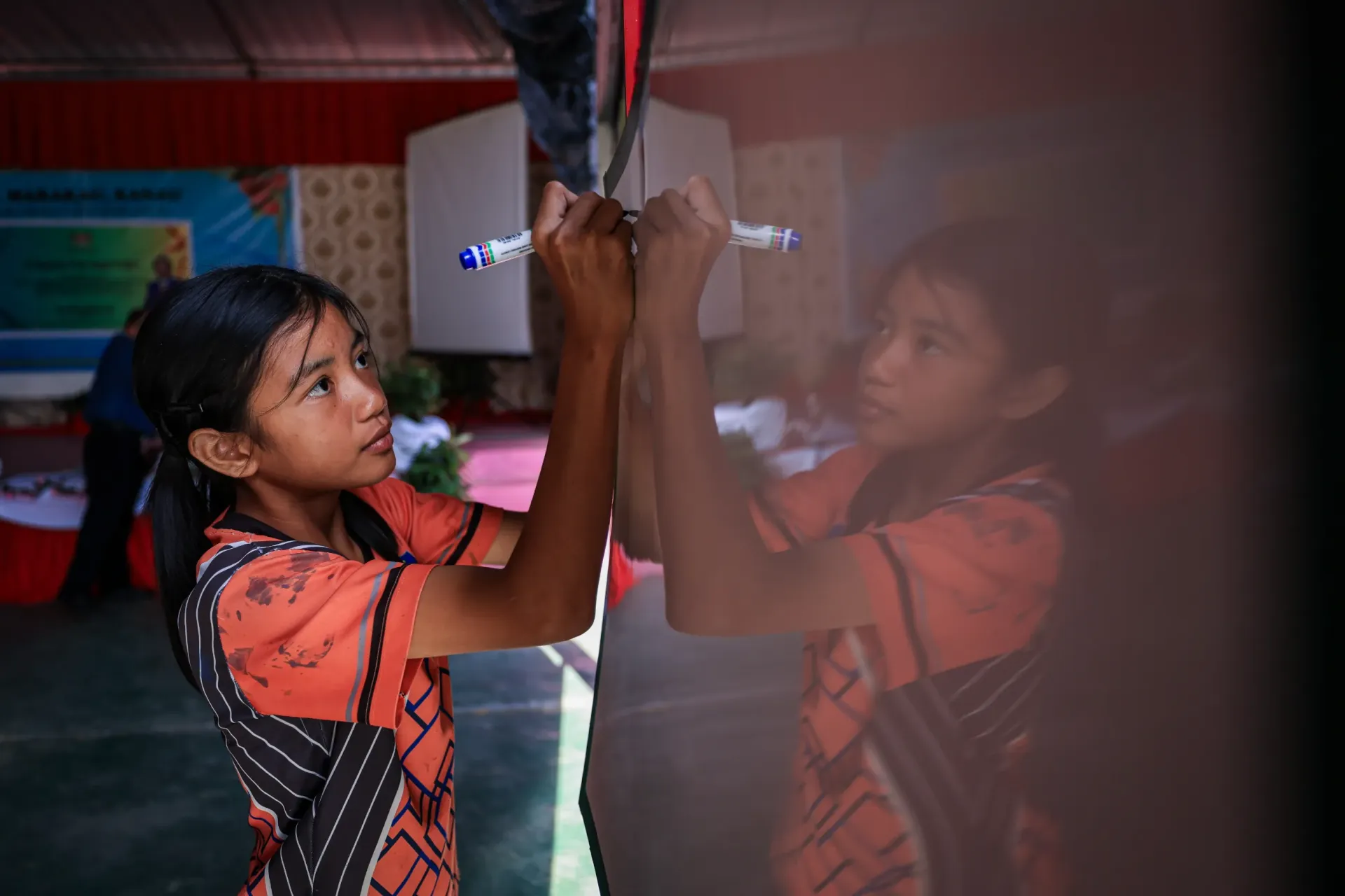 A student writes on a white board during the Disaster Risk Reduction (DRR) program organized by the Ministry of Education Malaysia, held at SK Marakau on September 6, 2024, in Ranau, Sabah, Malaysia.
