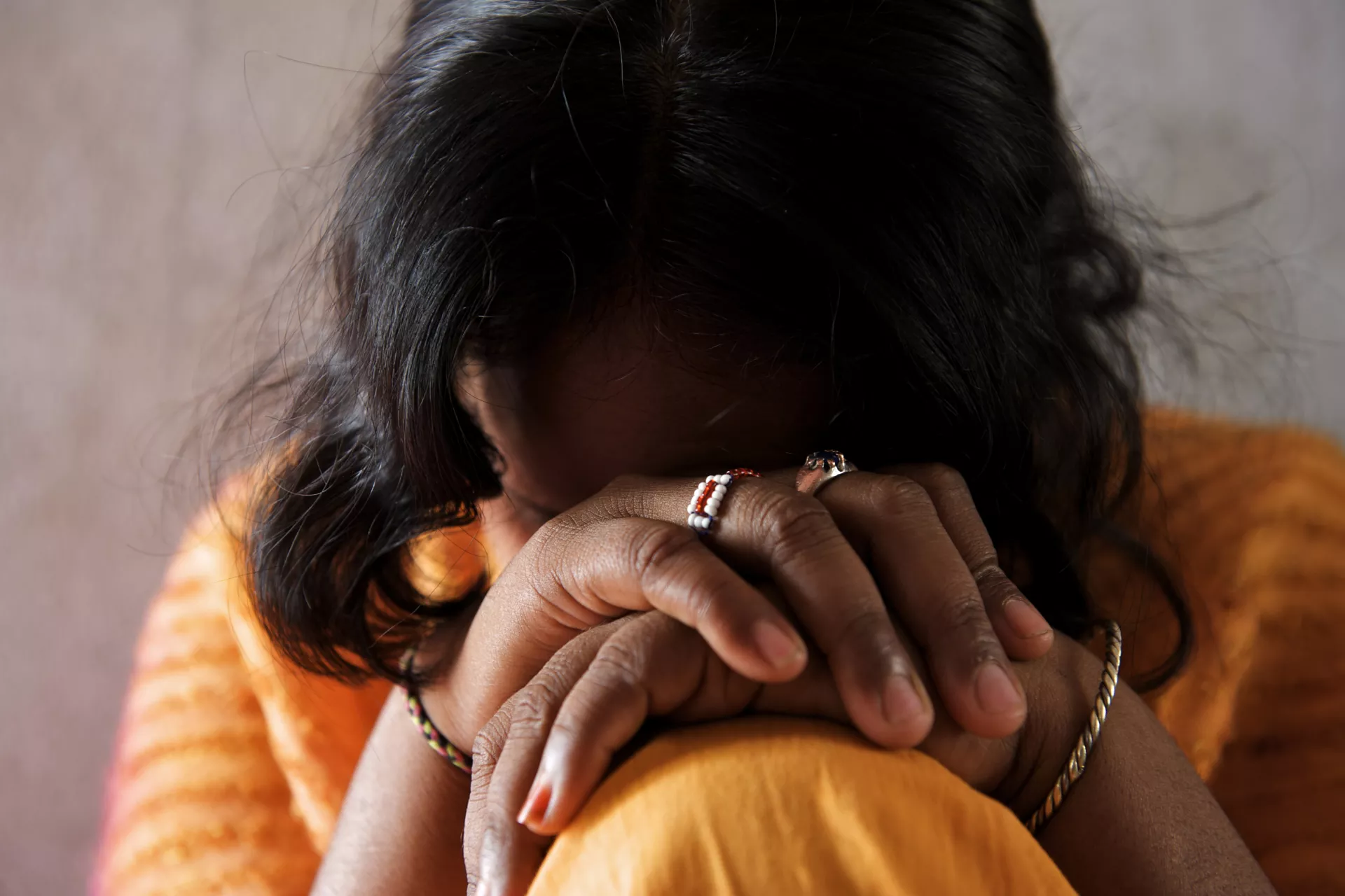 teen girl with head on hands