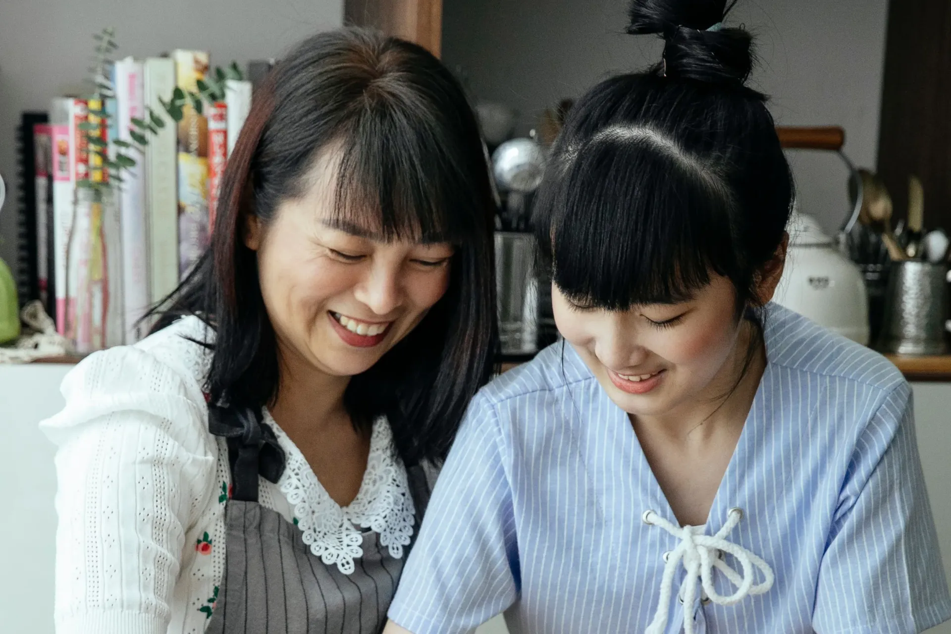 Mother and teen daughter laughing together 