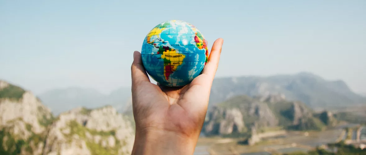 Person holding globe