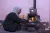 Farha, 45, tends to the wood stove in her apartment in Shabaa village, Rural Damascus.