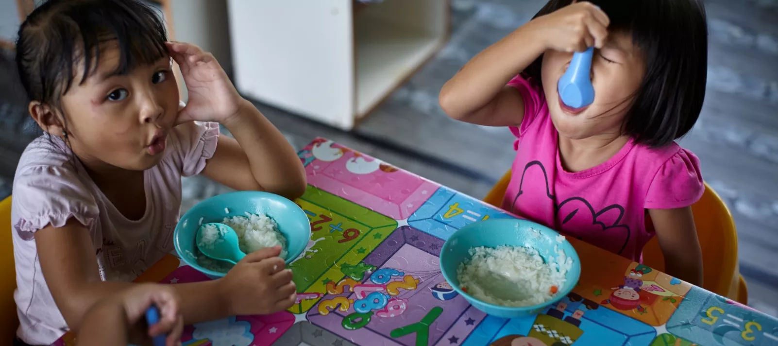 two children eating rice