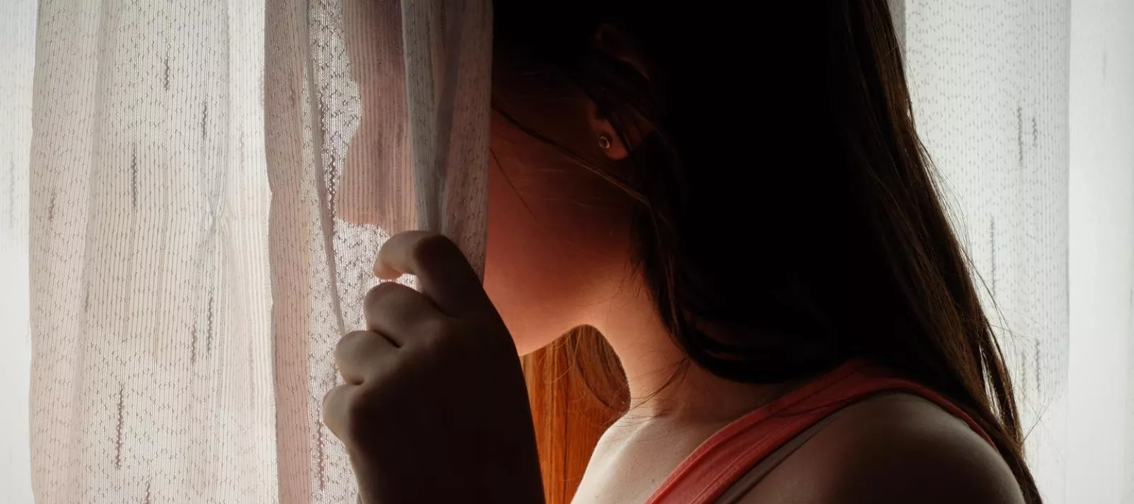 Girl behind curtain
