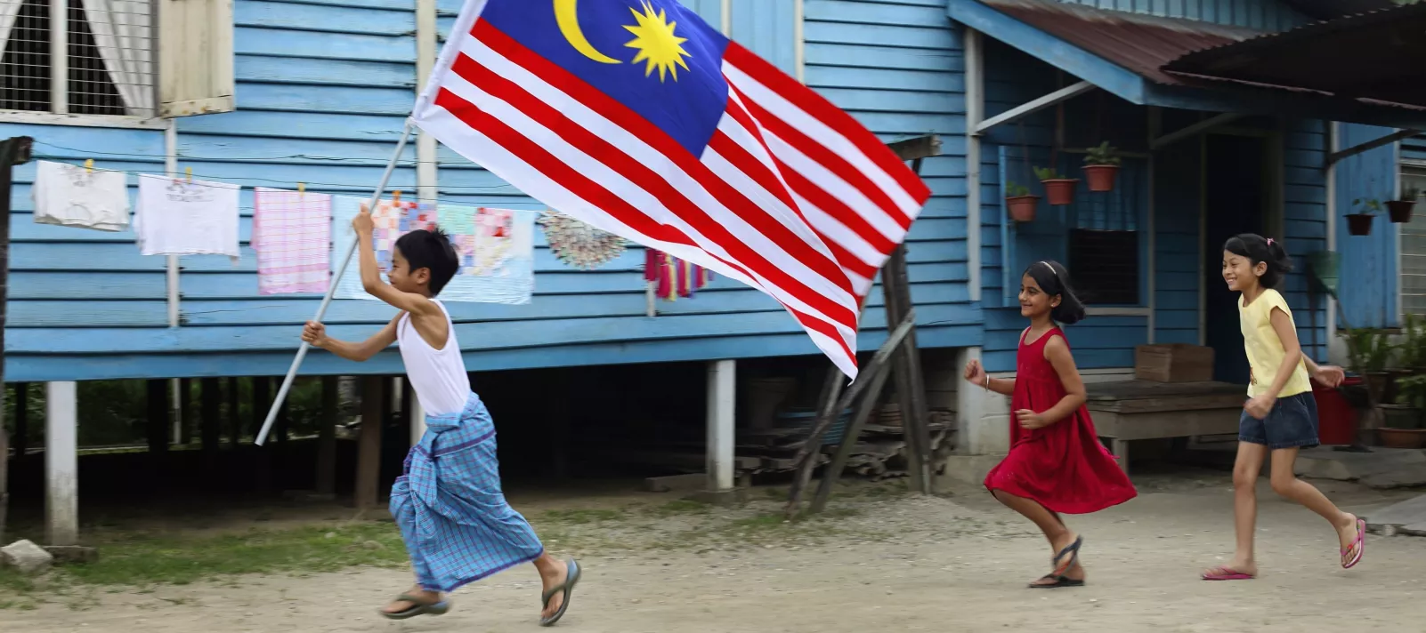 Children running with Malaysia flag