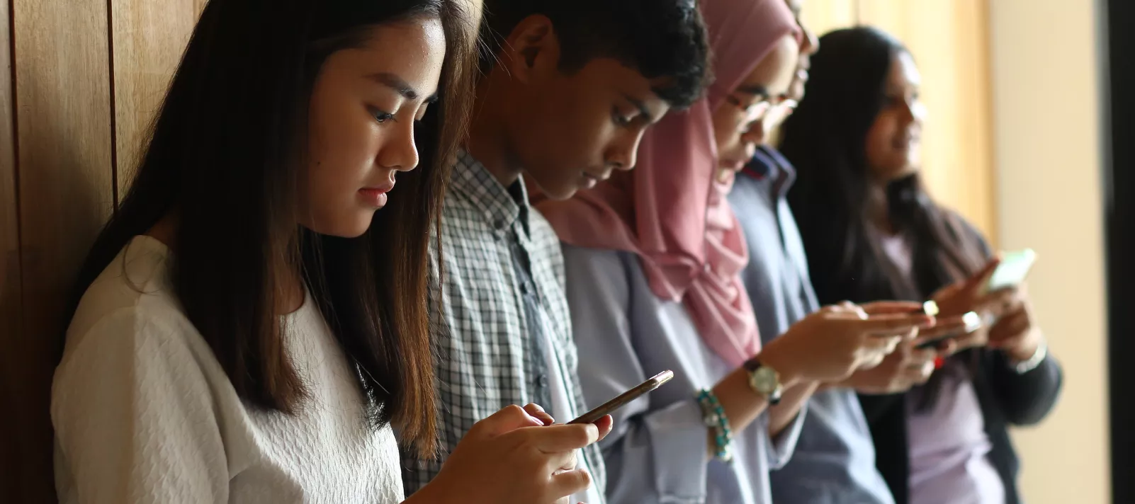 Teens looking at their phones