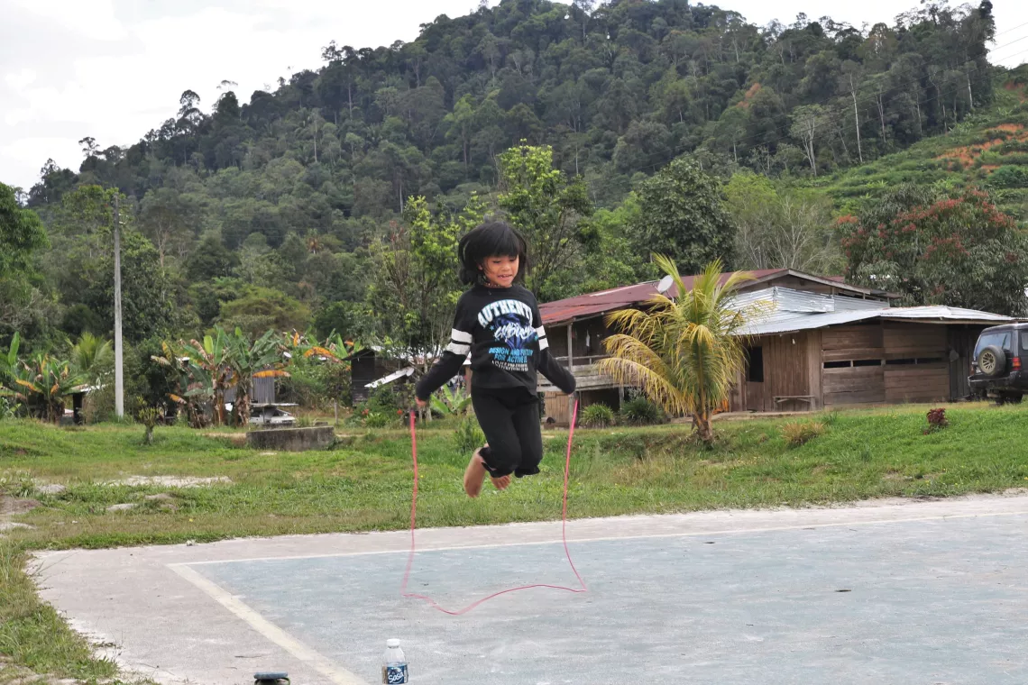 A girl skipping rope in a field