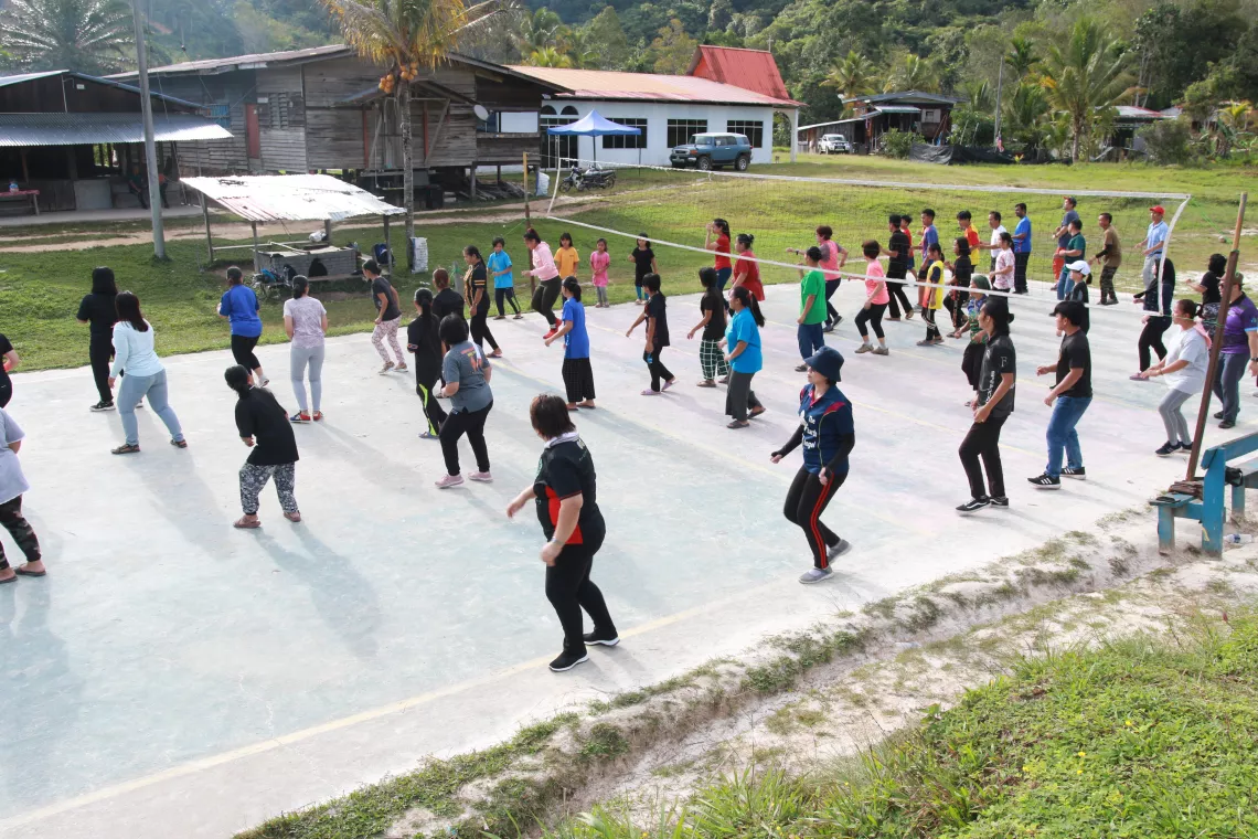 Medical staff and children doing exercises on a field