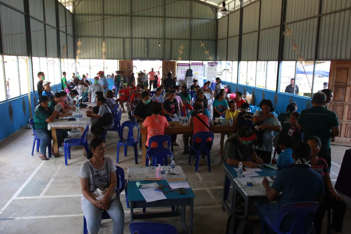 Families and children visit doctors at mobile clinic