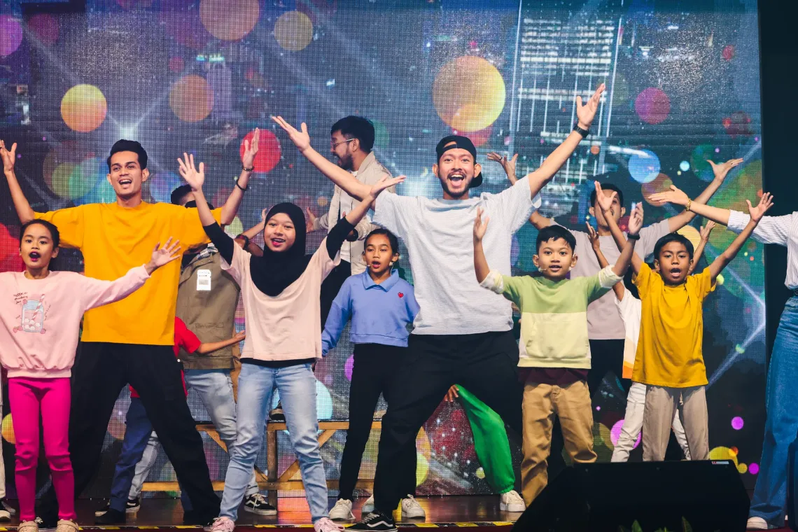 Children performing on stage during MBPJ CFCI ceremony