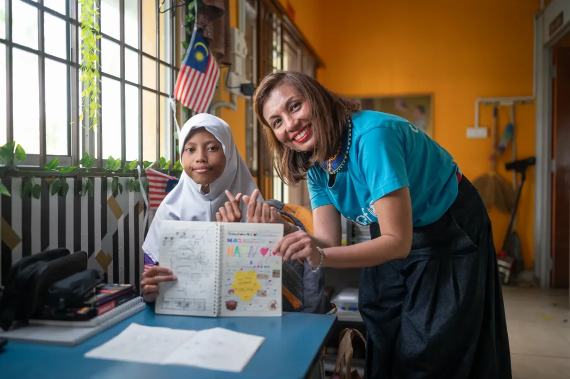 This is me with Una, who proudly shared her artwork. She loves to draw and dreams of becoming an artist one day.