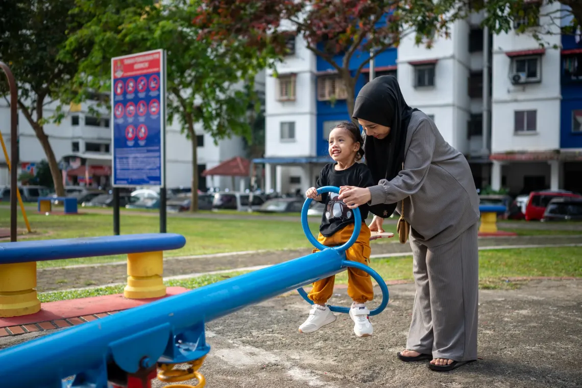 Ima loves  playing with Aaira daily at the playground below her home in a PPR complex in Kuala Lumpur. Moments like this reflect the everyday hopes parents hold for their children &ndash; to grow, play and thrive. 