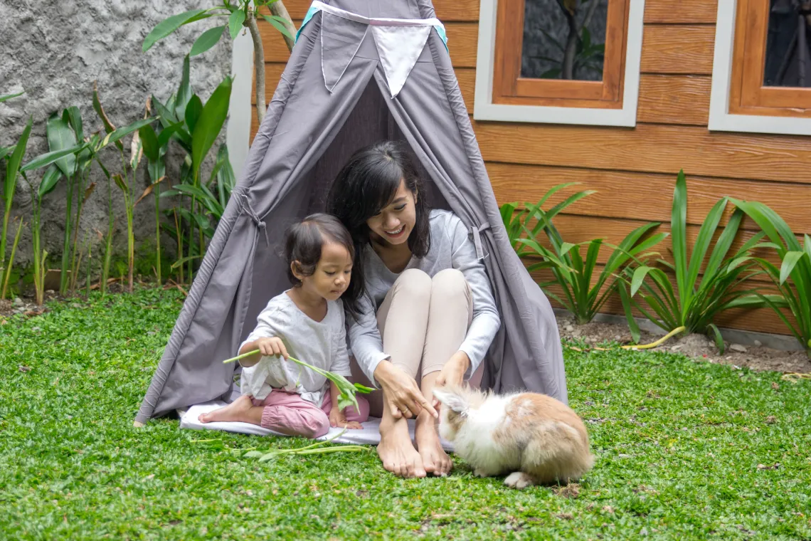 mother and daughter in camping tent