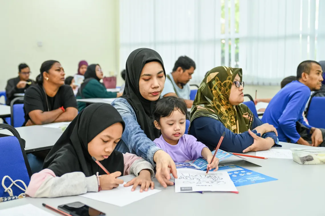 Ima attends an ASUH KL nutrition clinic with her daughters at a community library in Kuala Lumpur. 