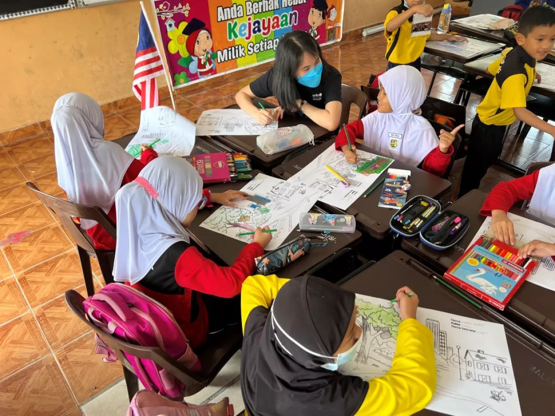UNICEF staff assisting students during groupwork