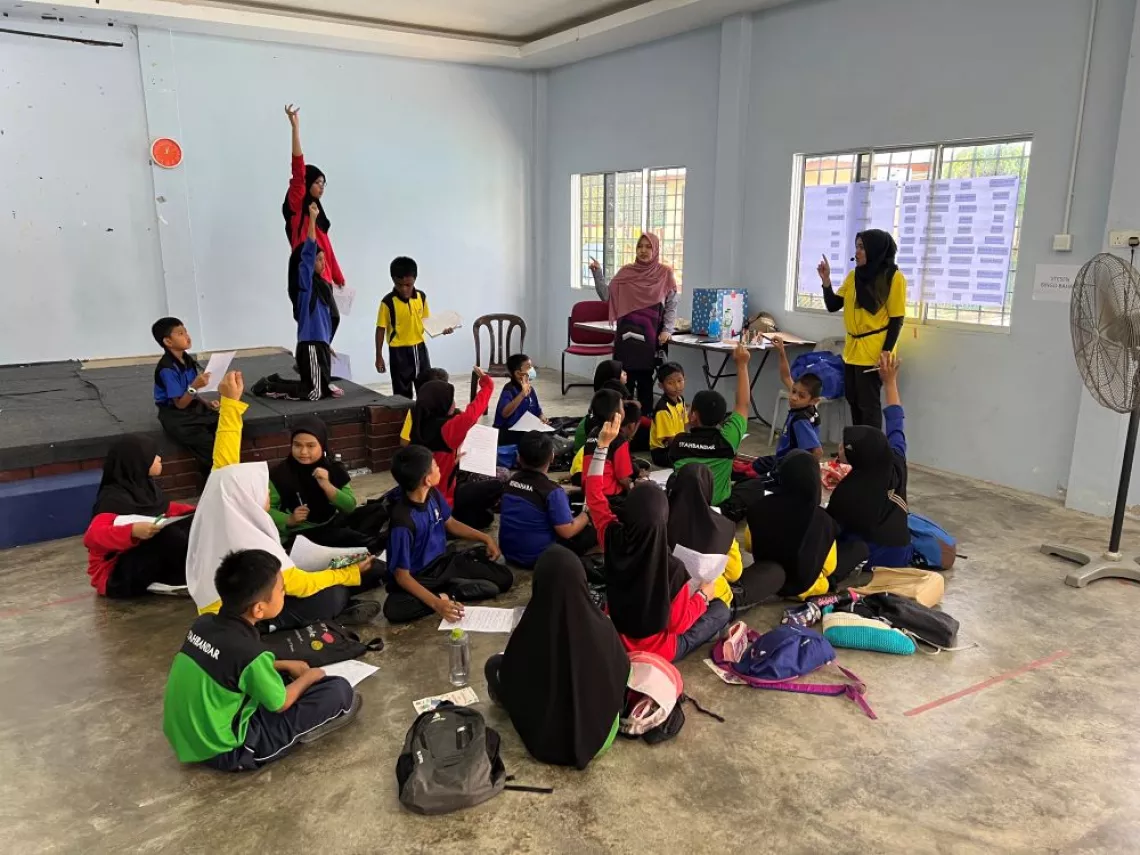 Students listening to a briefing in hall
