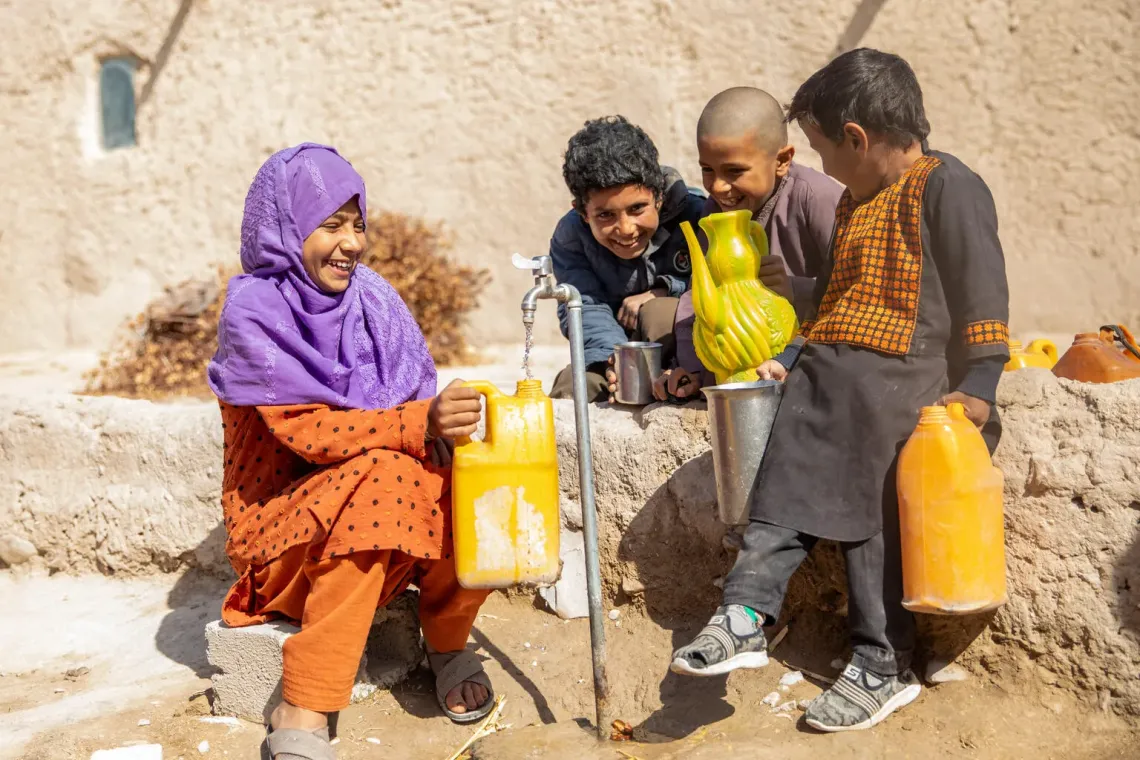 Children collect safe water from a new tap in Farah Province, Afghanistan. With UNICEF-supported water systems, families can access clean water closer to home, helping children stay healthy, learn and enjoy the simple joy of childhood.