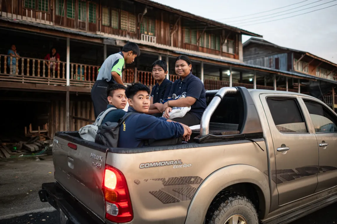Children hopping onto the back of a 4x4 truck on their way to school is a common sight in rural Sarawak, where access can be difficult due to poor road conditions.