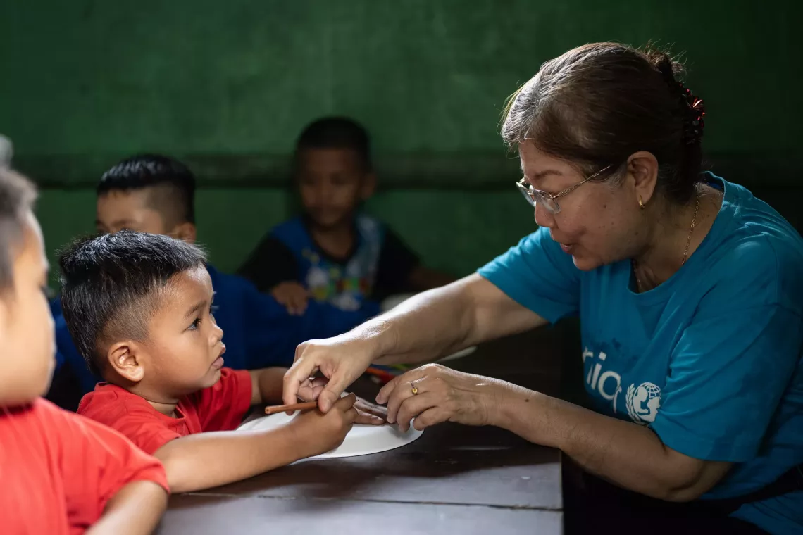 UNICEF Malaysia staff pictured with a child during a mission