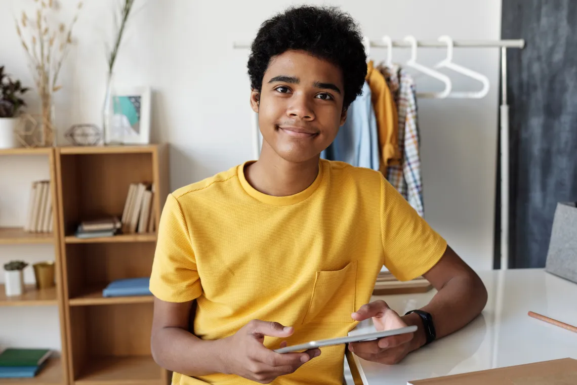 Teen boy holding tablet