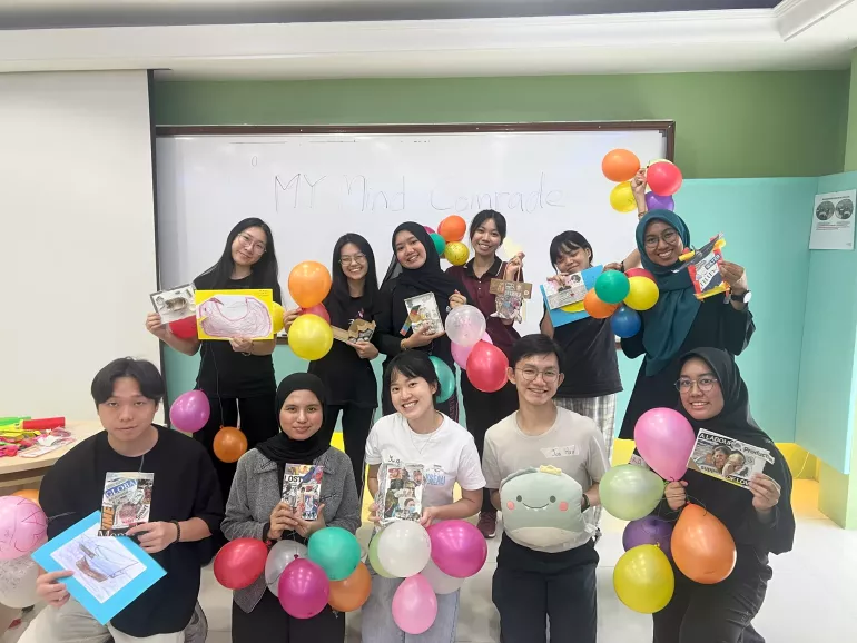 Teens pose with balloons at the LY workshop