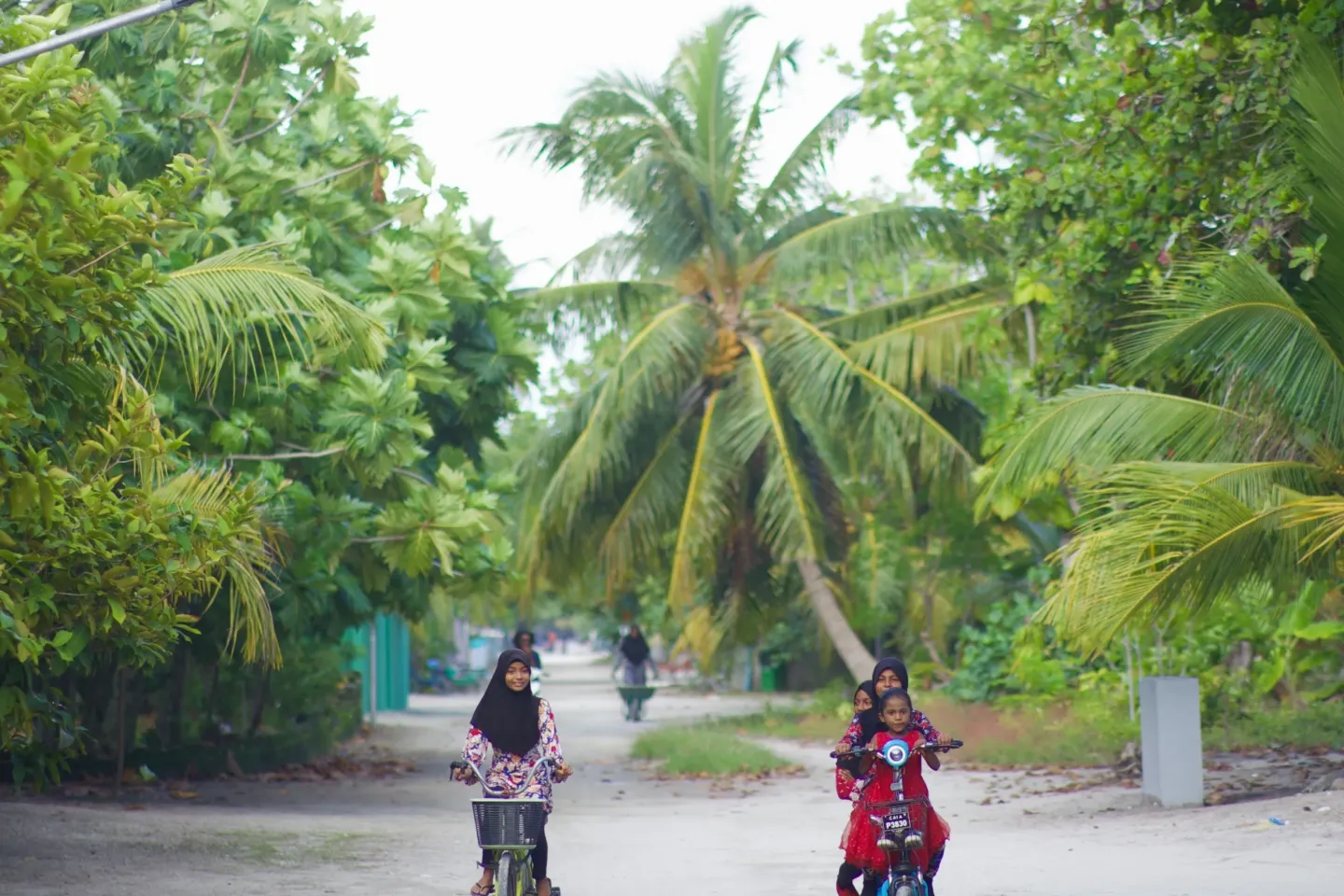 Two girls riding bicycle and cycle on an island