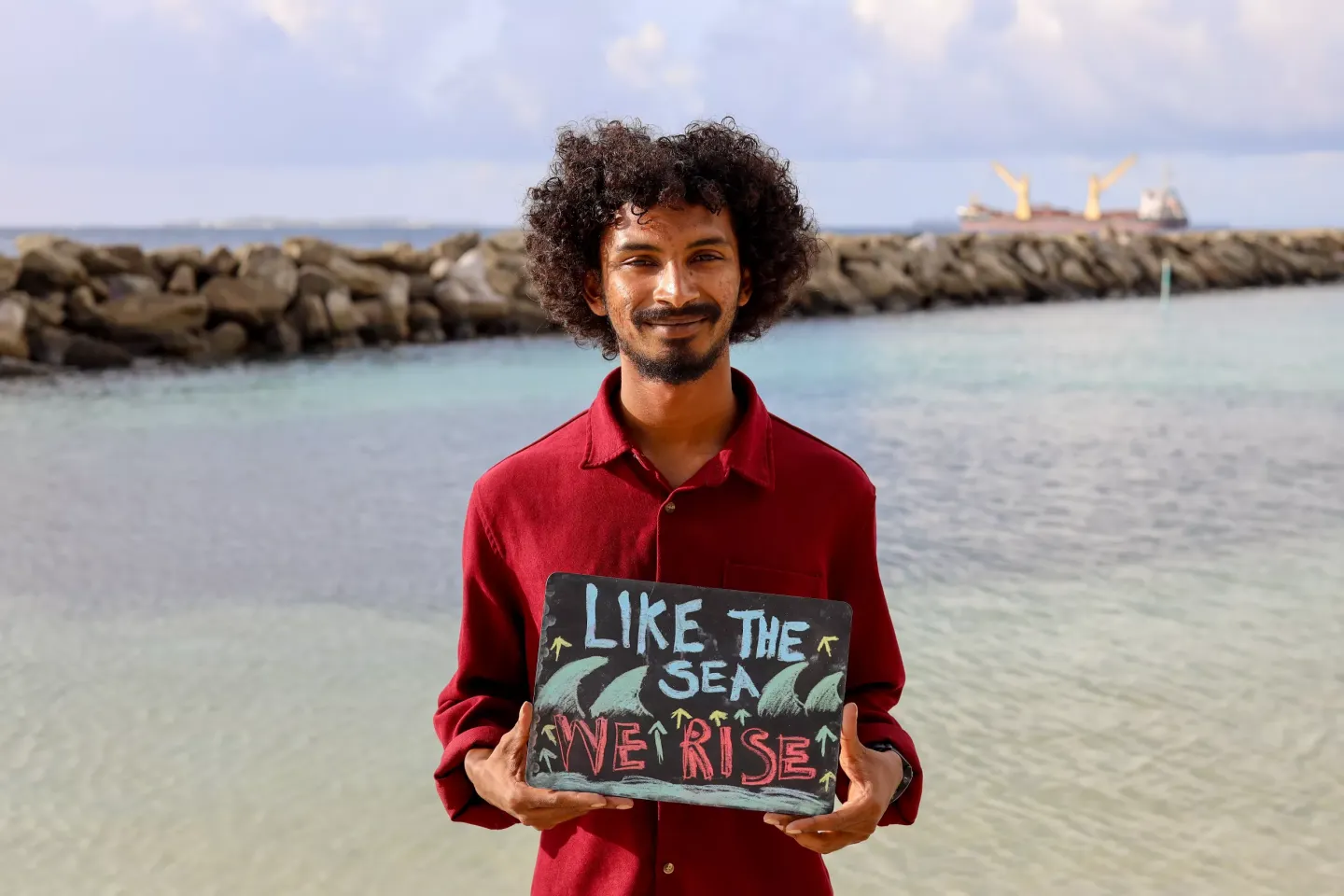 A young person with a climate change awareness sigh